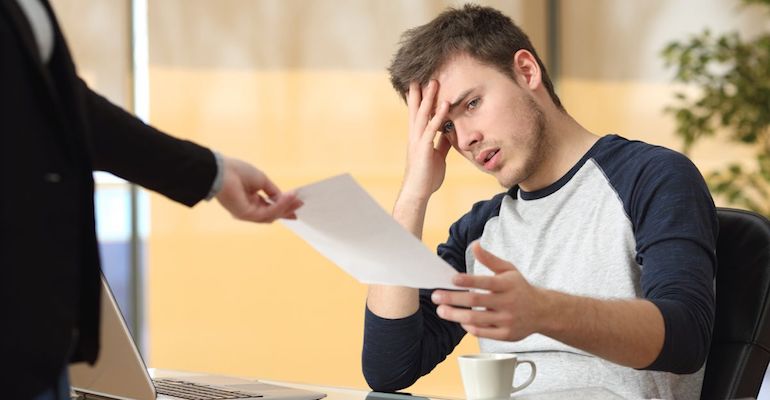 man upset while receiving paperwork from female employer