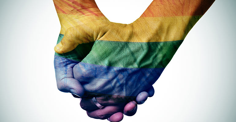 two men holding hands with rainbow overlay