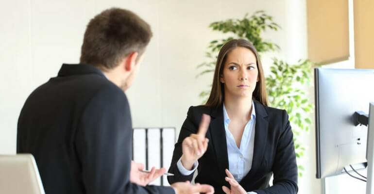are you protected from workplace retaliation business woman shaking finger at male coworker