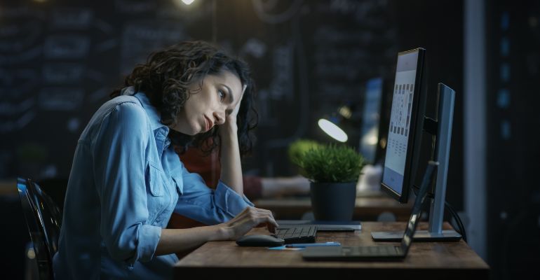 Woman upset at her desk after being denied time off