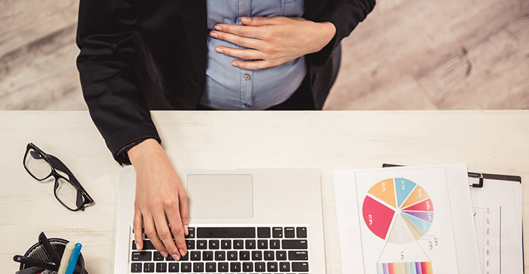 pregnant woman working at desk