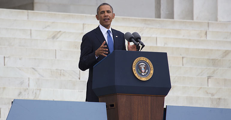 President Obama standing at podium speaking outside