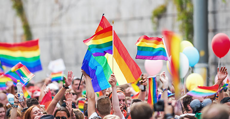 LGBT event with people holding gay pride flags