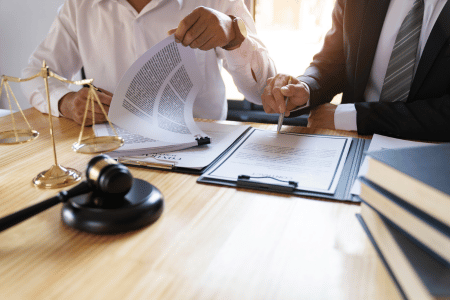 Lawyer and client reviewing wrongful termination case paperwork