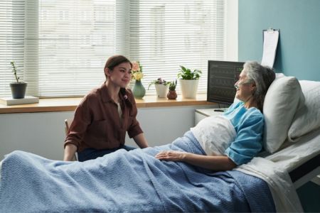 Family Member Visiting Elderly Parent in Hospital During Medical Recovery.