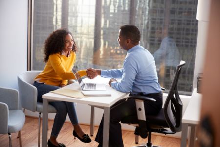 Woman in meeting with man shaking hands