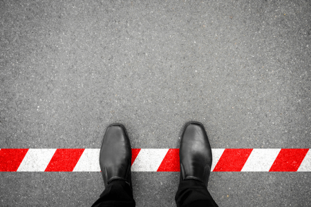 Person crossing a red and white line