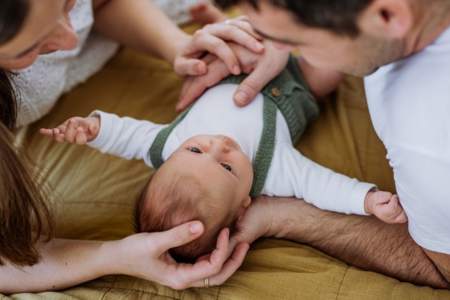 Mother and father on leave playing with their baby