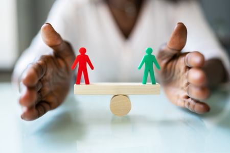 workplace pay imbalance balance scale between employees