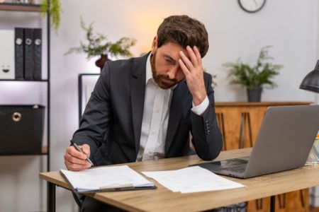 employee reviewing background check documents at desk.