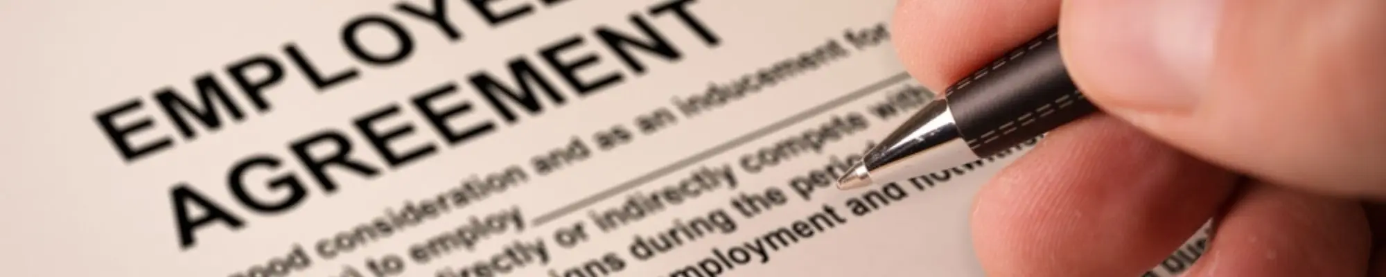 Business professional signing an employee non-compete agreement