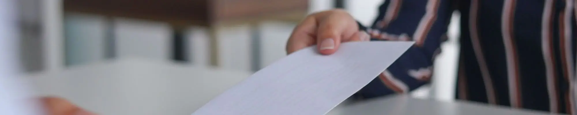 Employee receiving a severance document during an office meeting