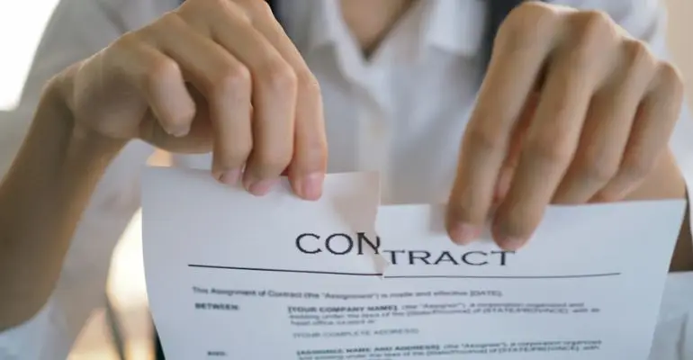 Person tearing employment contract.