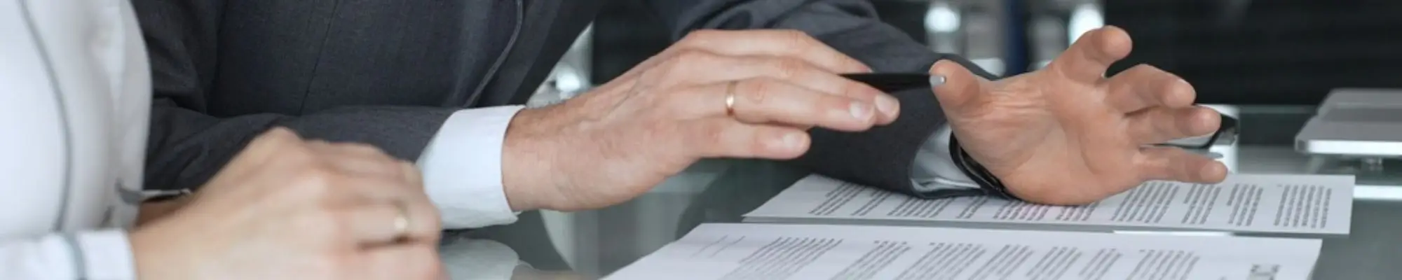 Legal professionals discussing documents during a case review meeting