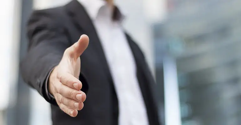 man standing and extending right hand out