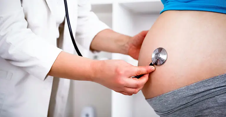 pregnant woman being examined by doctor