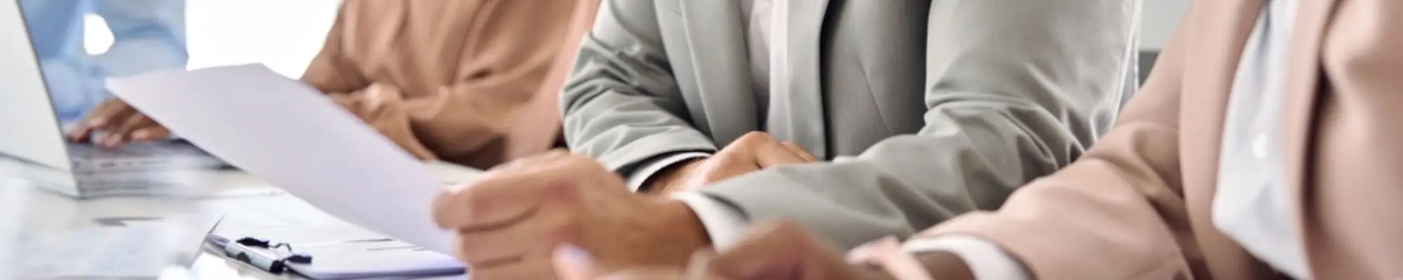 Group of professionals reviewing documents together during an office meeting