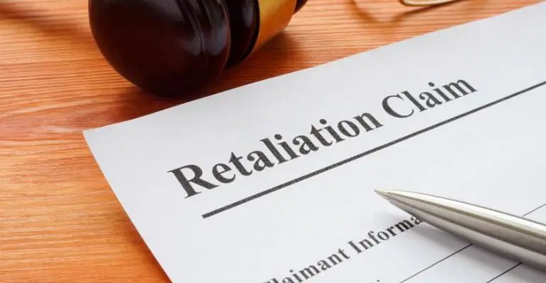 retaliation claim form with gavel and legal document.